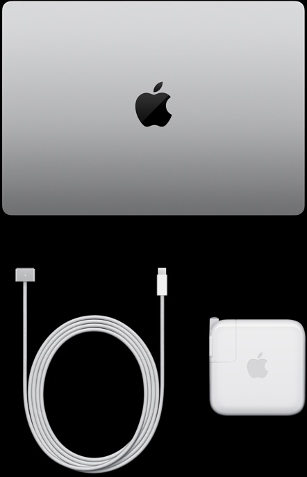 呈闭合状态的银色 MacBook Pro 的俯视图，旁边摆放着充电线和电源适配器。