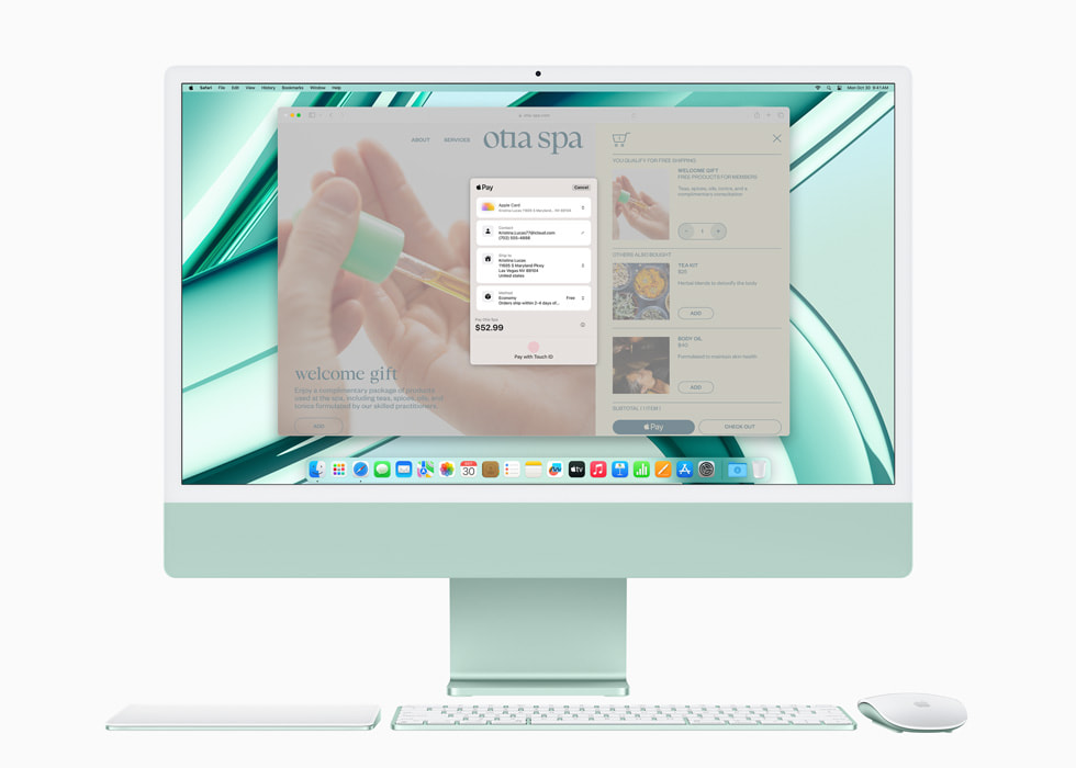 图中是 Apple Pay 的画面，显示在搭载 M3 芯片且搭配同系列配色键盘和鼠标的绿色新款 iMac 的显示屏上。
