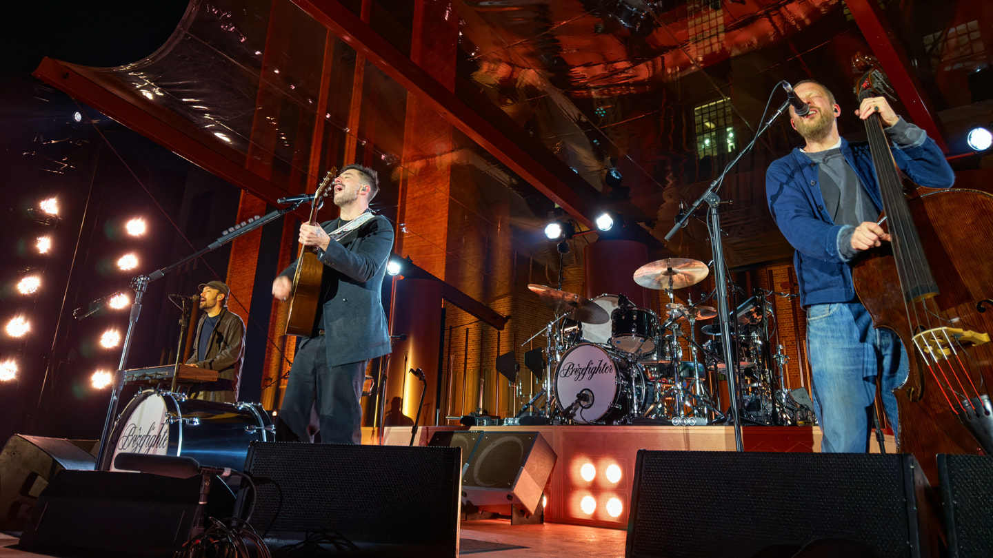 Mumford & Sons 乐队成员在伦敦 Apple Battersea 零售店外的舞台上表演。