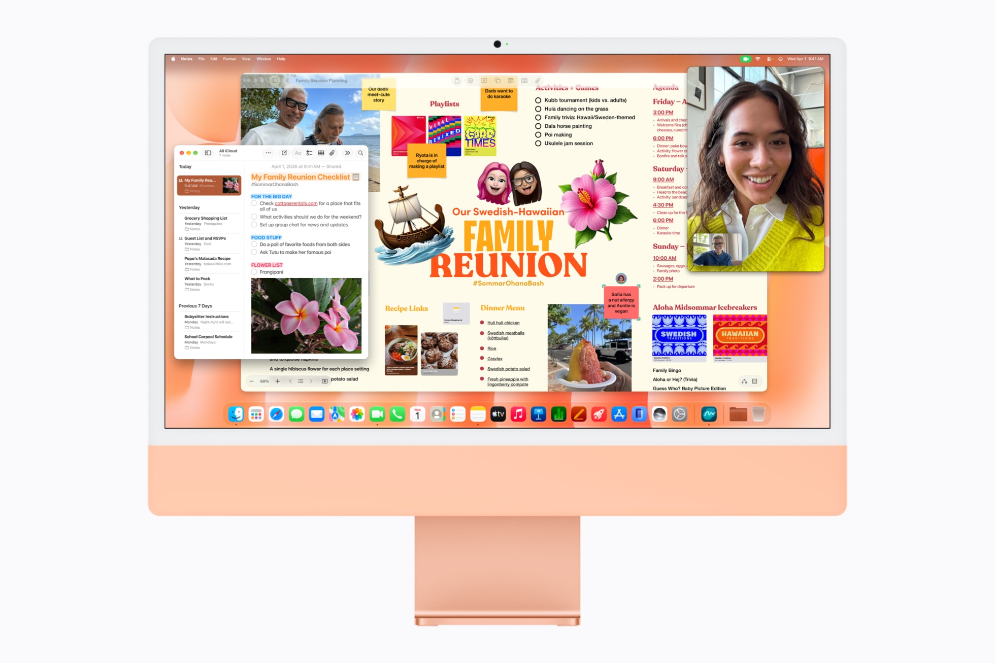 搭载 M6 芯片的橙色 iMac 上，无边记 app 中显示着家庭团聚计划，旁边是备忘录和 FaceTime 通话 app。
