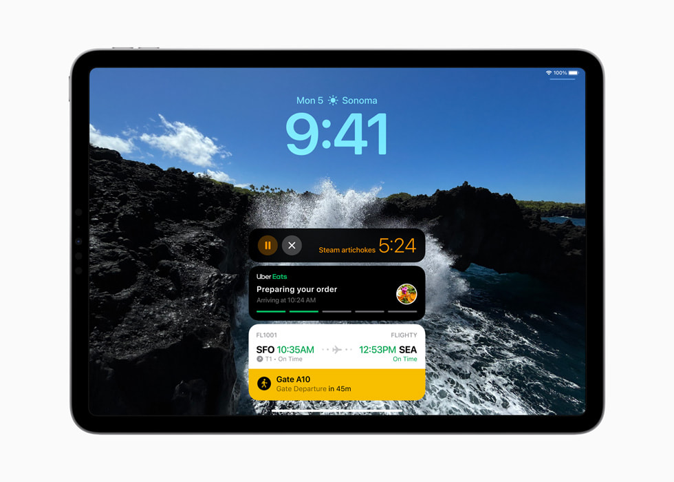 iPad Pro 在锁定屏幕上显示实时活动，包括计时器、Uber 外卖订单与航班信息。