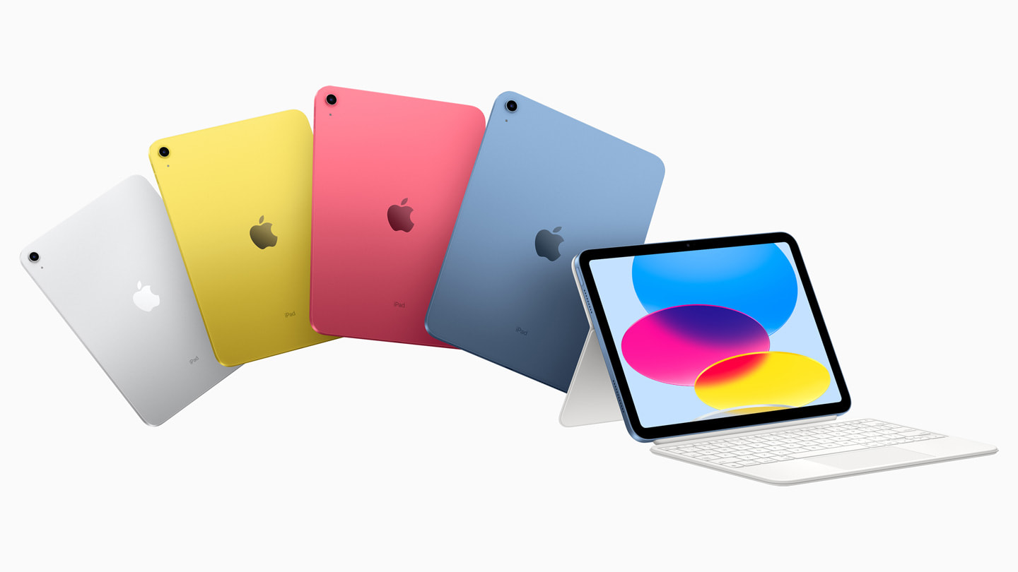 四种配色的新款 iPad 背面，其中的银色 iPad 搭配妙控键盘双面夹。