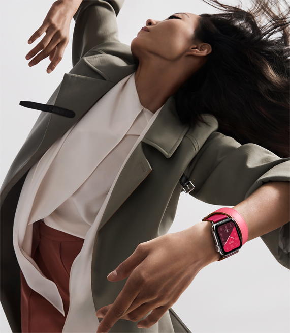 一个佩戴搭配亮丽拼色表带 Apple Watch Hermès 的女子。