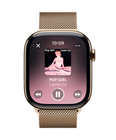 金色钛金属 Apple Watch 搭配米兰尼斯表带，表盘显示 Apple Music 正在播放音乐，控制按钮为半透明的 Liquid Glass 设计。