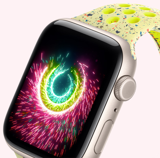 Apple Watch SE 3，展示星光色铝金属表壳搭配荧光黄绿色 Nike 运动表带，健身圆环闭合时如烟花般闪耀