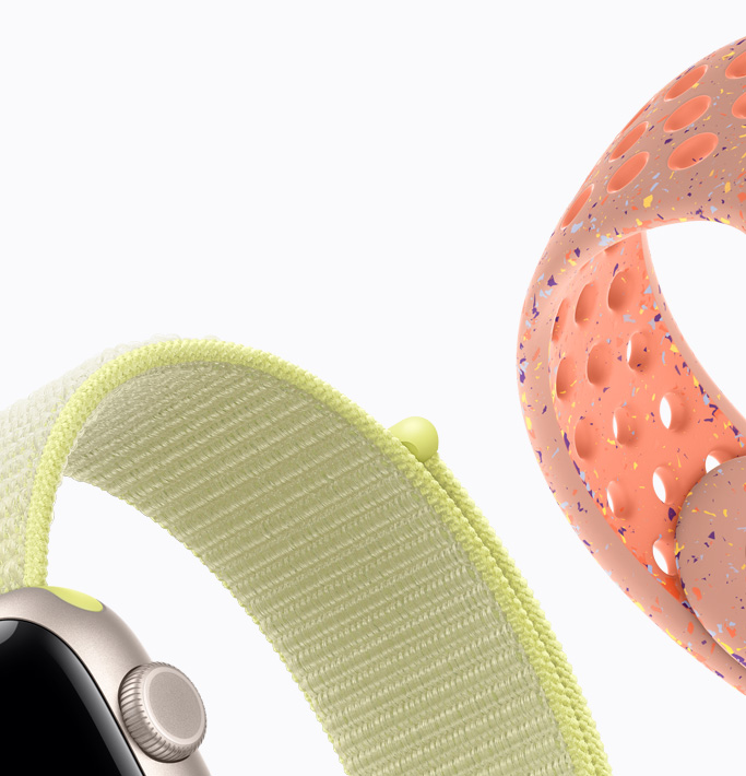 Apple Watch SE 3，展示星光色铝金属表壳搭配霓虹黄色回环式运动表带，以及山霞粉色 Nike 运动表带