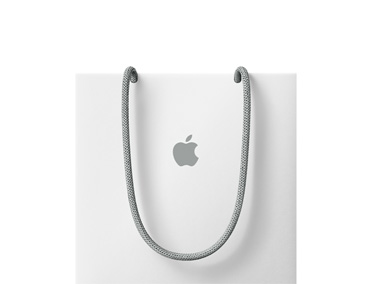 白色 Apple 购物袋，配有灰色手提绳，袋身中央印有灰色 Apple 标志。