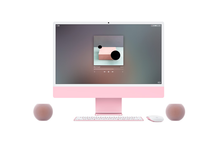 粉色 iMac 的正面外观，屏幕显示 Apple Music 正在播放音乐，同色系的妙控键盘和妙控鼠标摆放在下方，两侧各放置一部粉色 HomePod mini 2 扬声器以组建立体声组合。