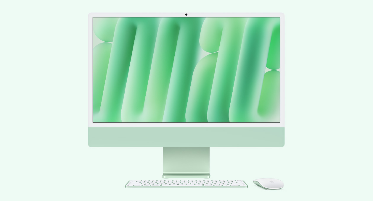 绿色 iMac 正面外观，搭配同色系妙控鼠标和妙控键盘。