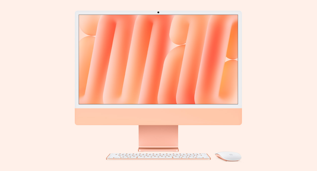 橙色 iMac 正面外观，搭配同色系妙控鼠标和妙控键盘。