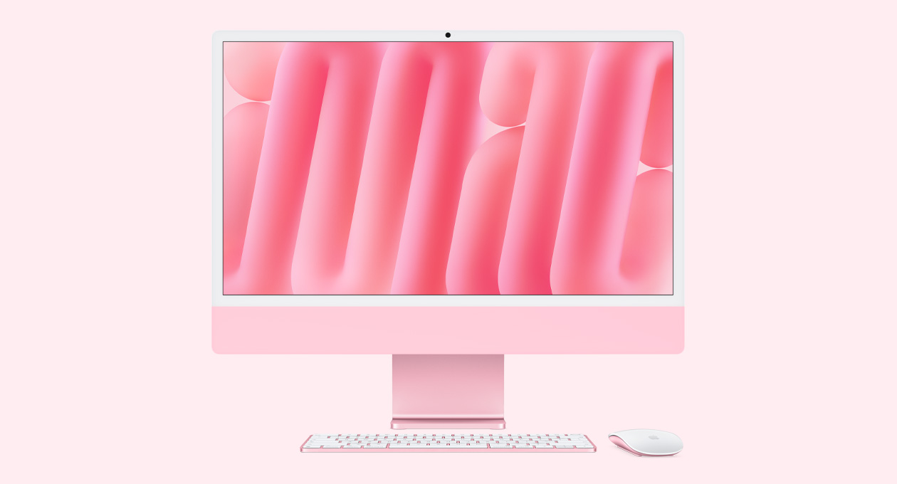 粉色 iMac 正面外观，搭配同色系妙控鼠标和妙控键盘。