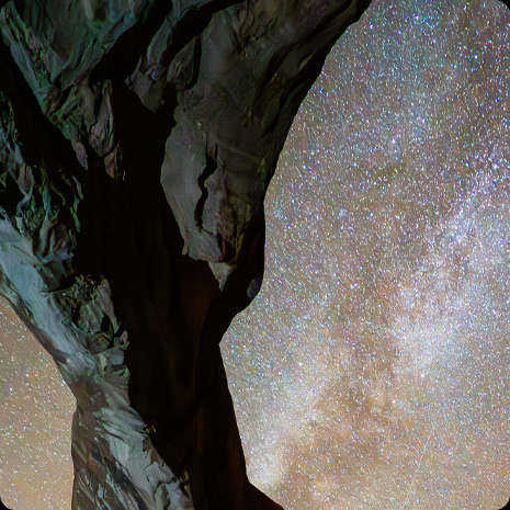 一张背景为星空、前景为岩石结构的照片。