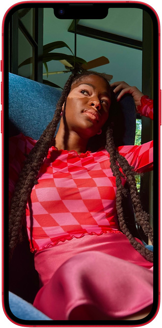 iPhone 14 Plus 上显示着一个身着亮粉服装的人。