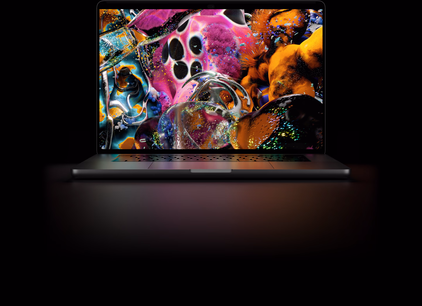配备 PROLED XDR 显示屏的 MacBook Pro，深空黑色外观，屏幕显示细节丰富、色彩生动的高对比度图像，屏幕发光照亮键盘。
