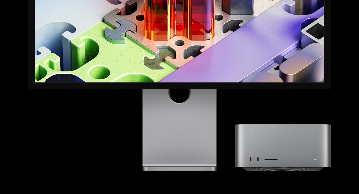 Mac Studio 与 Studio Display XDR 搭配，Mac Studio 收置在屏幕下方：Studio Display XDR 展示拼图风格的三维墙纸。